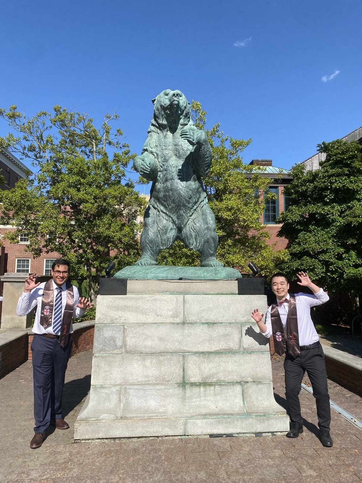 Posing at the Brown Bear statue on graduation day