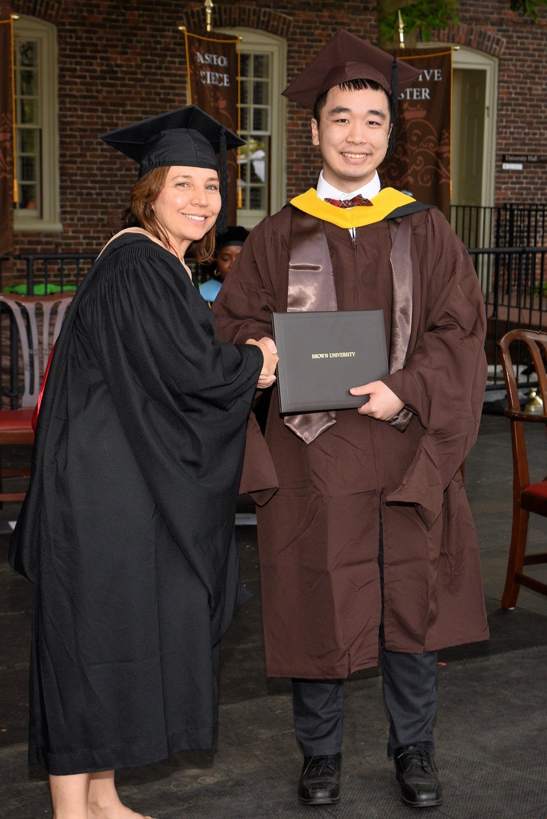 Receiving diploma at Brown graduation